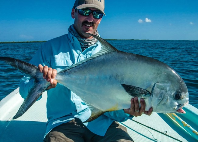 Patrick on a hot day in Boca Paila with his catch.