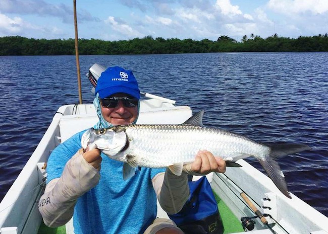 Benjamin showing his fish in Akumal after an incredible fishing tour.