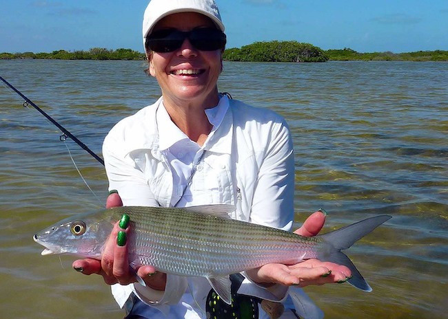 Helen proud to fish with the help of a guide on the Cozumel fishing tour.
