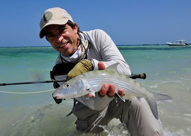 Bryce showing his catch during a fly fishing trip he took with his family.