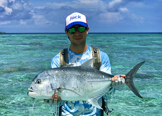 Bobby very happy by the fish he caught on a sunny day in Cozumel.