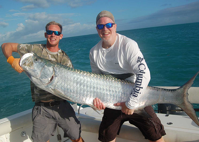 Kenneth and his son showing off the big game they caught in their fly fishing tour.