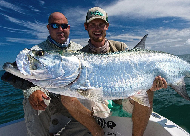 Ronnie and his father with their big game during a fly fishing excursion in Cozumel.